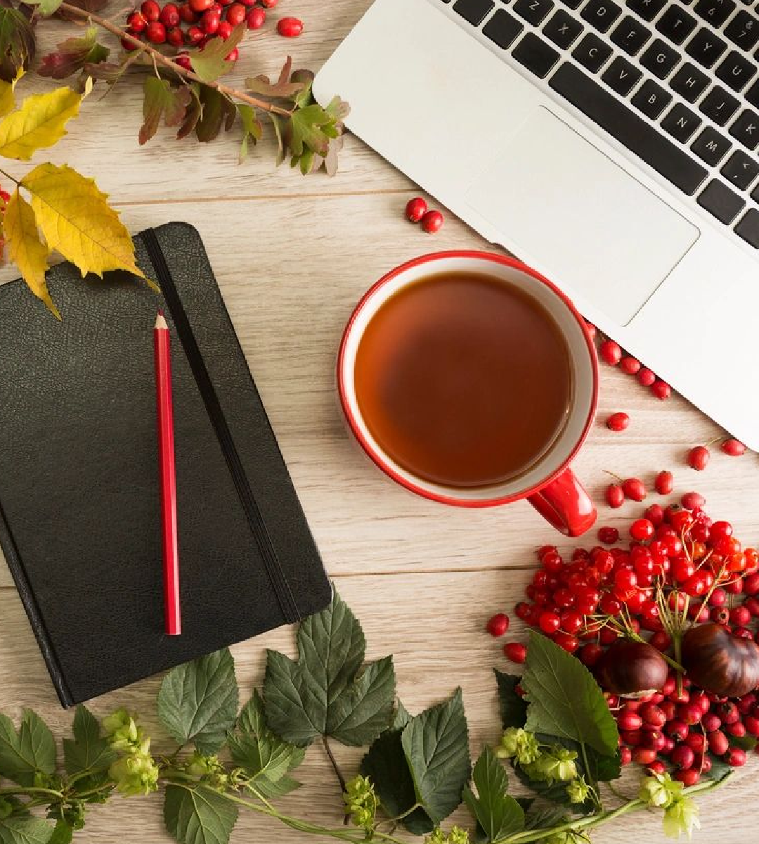 A cup of tea and some leaves on the table